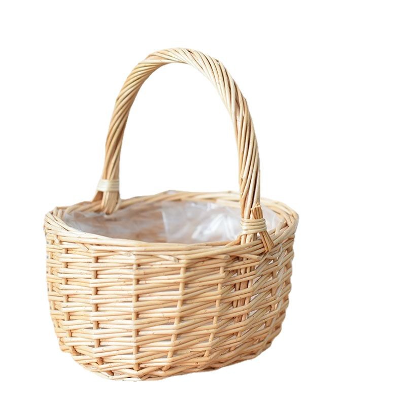 Our handwoven wicker basket with handle is crafted from natural willow. This handwoven wicker basket features a sturdy handle for easy carrying. The handwoven willow basket is ideal for fruit storage and gifting.