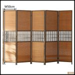 Bamboo folding screen with pine frame standing open in a living room